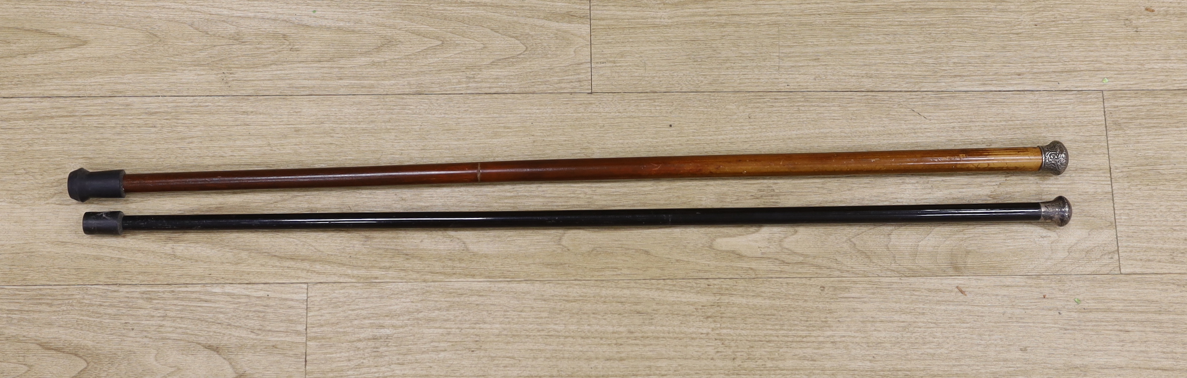 Two Victorian silver mounted canes, longest 93cm